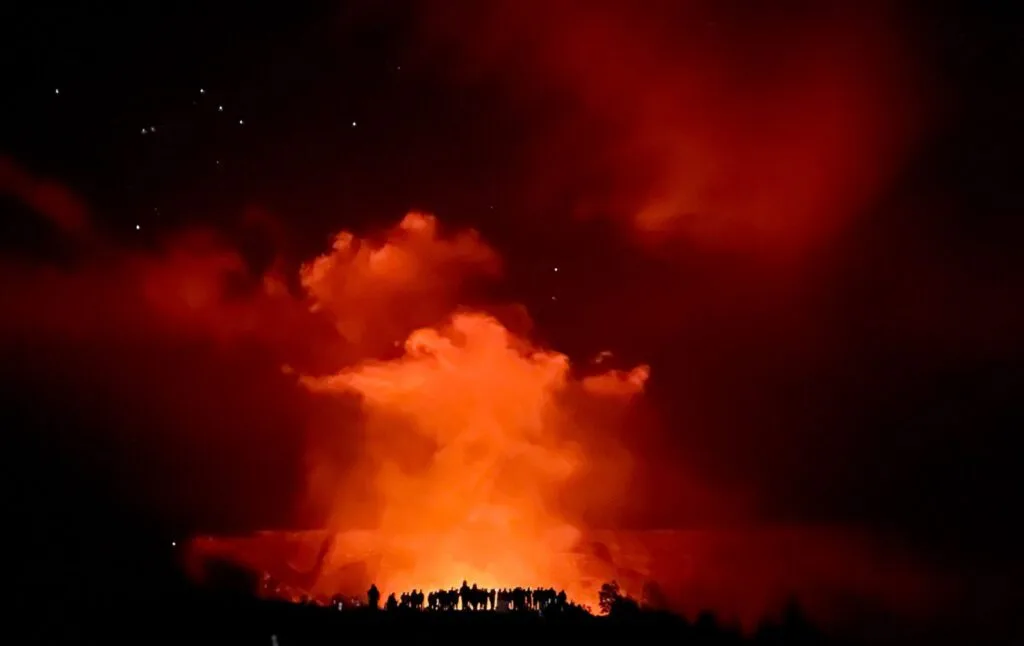 people gathered around Kilauea crater watching volcanic eruption in Hawaii Volcanoes National Park, minutes away from At the Crater's Edge